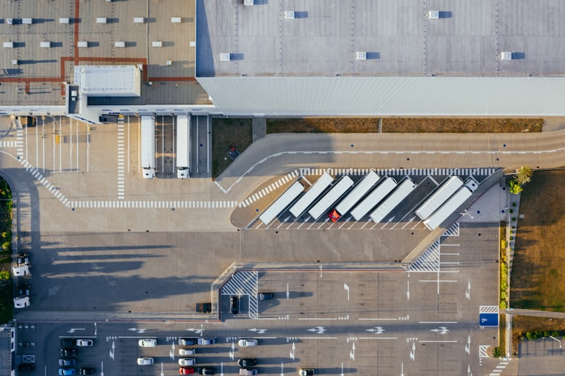 Aerial view of a logistics depot with trucks at loading bays
